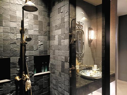 a bathroom with a shower and a sink at Chombua MaeWang ชมบัว in Chiang Mai