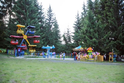 a park with a playground with a roller coaster at Cristal Loft C block 203 room in Bakuriani