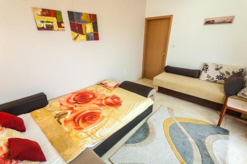 a living room with a bed with roses on it at Apartments Mila Krimovica in Krimovice