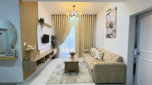 a living room with a couch and a window at Alora Homestay in Kajang