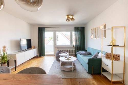 a living room with a couch and a table at Apartment Basilikablick I 3 Zimmer Wohnung mit Küche und Bad in Weingarten
