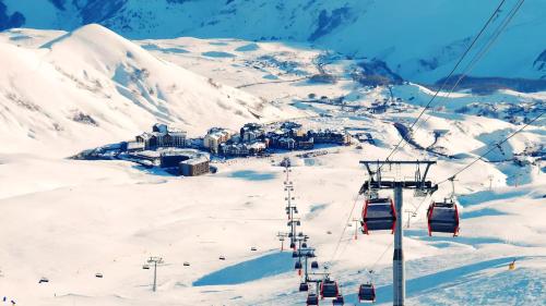 a ski slope with a ski lift in the snow at Cristal Loft C block 203 room in Bakuriani