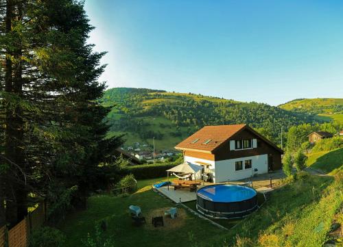 a house on a hill with a gazebo at Le petit coin de Jeanne et Marcel chalet de vacances La Bresse in La Bresse