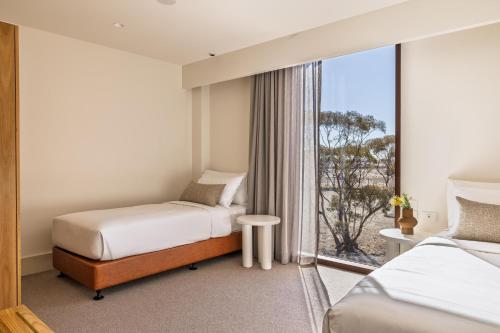 a hotel room with two beds and a window at Monarto Safari Resort in Monarto