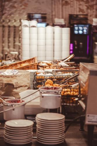 a kitchen with a counter with plates and pastries at AQUA Resort AQUAPARK in Międzyzdroje