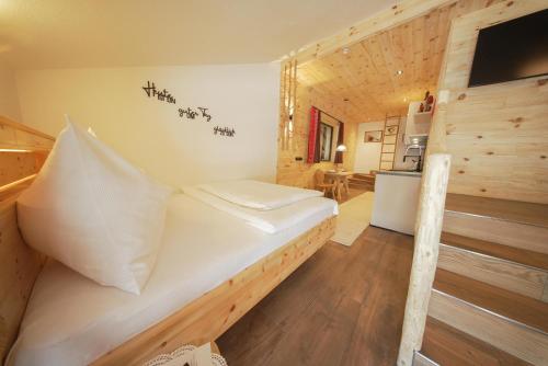 a bedroom with a white bed in a wooden room at Apartments Wiglhof in Jenbach