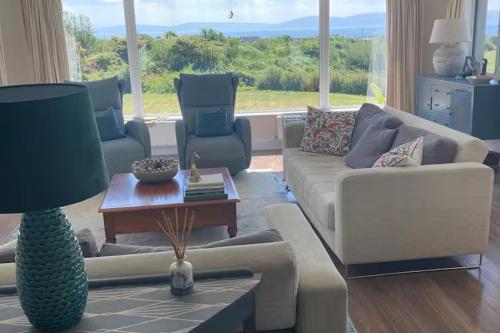 a living room with a couch and a table at Luxury Galway Getaway with 5 Bedrooms in Galway