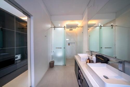 a bathroom with two sinks and a mirror at Cosy and Luxurious Villa Sentosa Seminyak in Seminyak