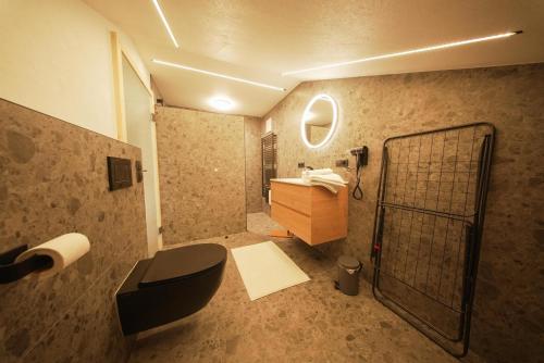 a bathroom with a black toilet and a sink at Apartments Wiglhof in Jenbach