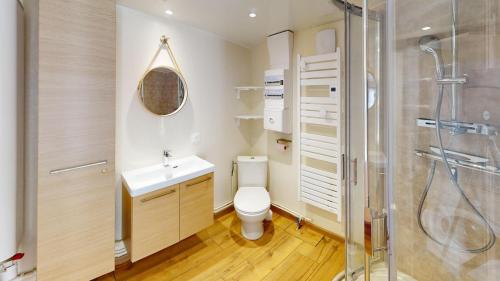 a bathroom with a toilet and a sink and a shower at Pagotin de charme à Métabief in Métabief