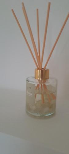 a glass jar with sticks in it with a candle at B&B La Loggia in Lonato del Garda