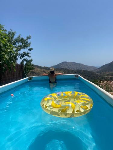 a man in a hat sitting in a swimming pool at Boutique B&B CASAITANA adults only in Sella