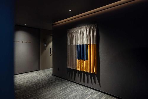 a painting on the side of a wall in a room at Ondo Hotel and Spa Jongno by Aank in Seoul