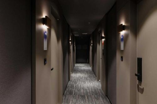 a hallway with a long corridor with lights on the walls at Ondo Hotel and Spa Jongno by Aank in Seoul