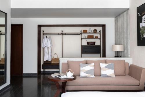 a living room with a couch and a table at Treeline Urban Resort in Siem Reap