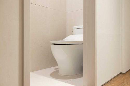 a bathroom with a white toilet in a room at Ondo Hotel and Spa Jongno by Aank in Seoul
