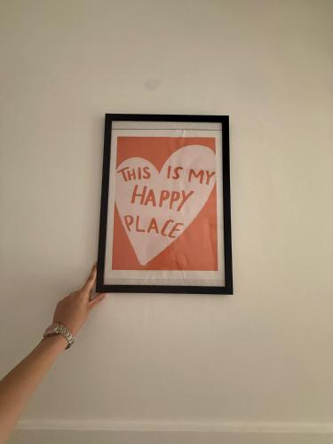 a person holding up a picture in a frame on a wall at Casa Mia in Alife