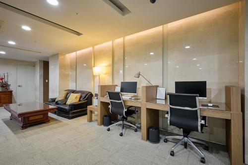 an office with a desk with two monitors and chairs at Summit Hotel Seoul Dongdaemun in Seoul
