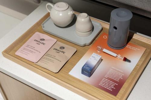 a wooden tray with items on top of a counter at Ondo Hotel and Spa Jongno by Aank in Seoul
