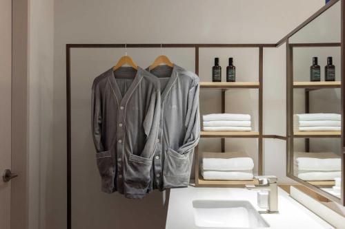 a jacket hanging on a rack in a room at Ondo Hotel and Spa Jongno by Aank in Seoul