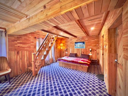 a bedroom with a bed in a wooden cabin at Royal Star Kasol in Kasol