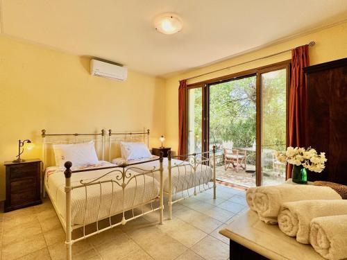 a bedroom with two beds and a large window at Beachfront Villa Calypso with private pool by DadoVillas in Acharavi