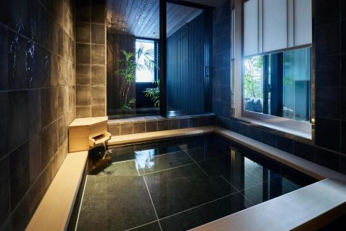 a swimming pool in a bathroom with a window at ふふ東京銀座 in Tokyo