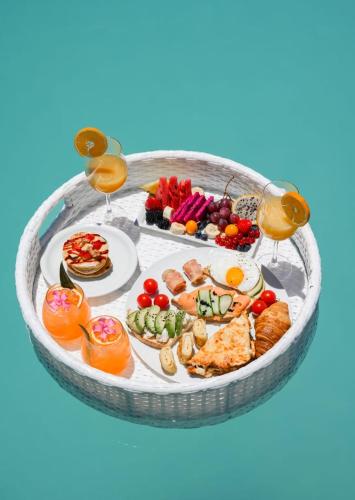 a tray of food on a table with glasses of wine at Ayama Hideaway Private Villa in Fira