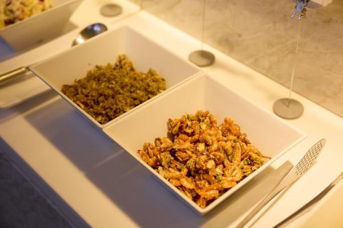 two white bowls of food on a counter at Summit Hotel Seoul Dongdaemun in Seoul