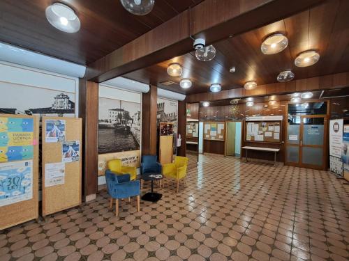 a room with chairs and tables in a building at Mediterranean Rooms Koper in Koper