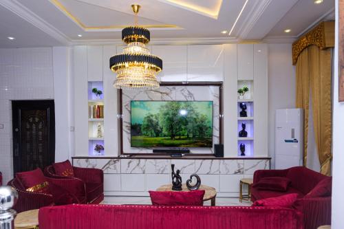 a living room with red furniture and a flat screen tv at luxury 3bed rooms duplex lekki Lagos nigeria in Lekki