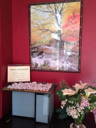 a painting of a tree and flowers on a wall at Hostal Restaurant Jose Luis in Trespaderne