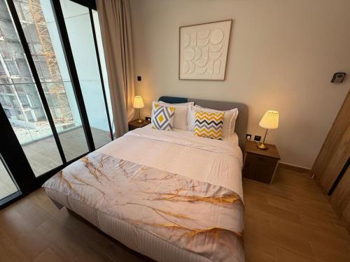 a bedroom with a large bed and a large window at Stylish Jr 1BR on Maryah Island near Cleveland by Central Stay in Abu Dhabi