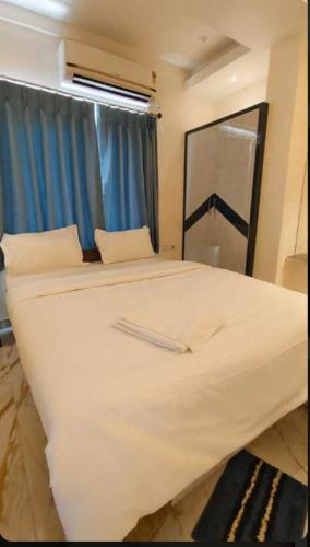 a large white bed in a room with a window at Hotel Passion Resort in Kolkata