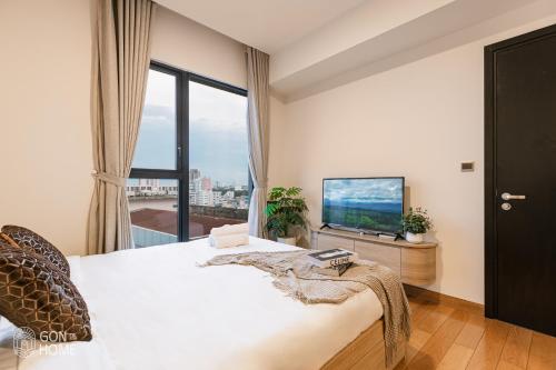 a bedroom with a large bed and a television at Luxury 2 or 3BR Apartment in Dist 1, Pool and airport pickup in Ho Chi Minh City