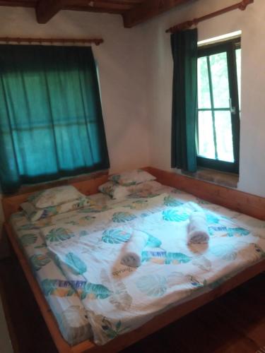 a bedroom with a bed with two babies on it at Panorama Vendeghaz in Dombóvár