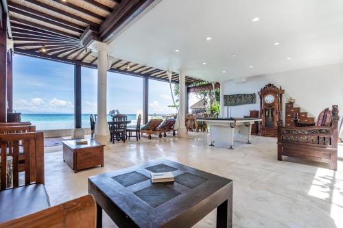 a large living room with a pool table and the ocean at The Village of Angels in Manggis