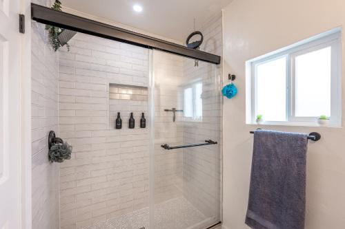 a bathroom with a shower with a glass door at Modern home near Downtown San Diego in San Diego