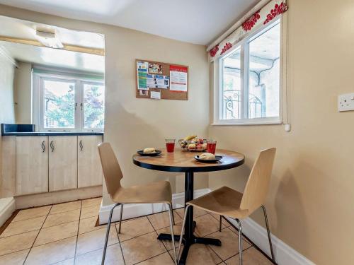 a kitchen with a table and chairs in a room at 3 Bed in Baslow PK908 in Baslow