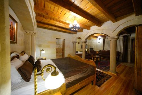 a bedroom with a bed and a living room at Harman Cave Hotel in Goreme