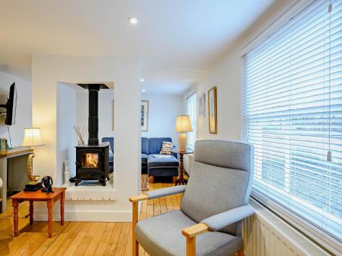 a living room with a chair and a fireplace at 2 Bed in Long Melford 81320 in Long Melford
