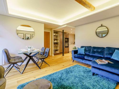 a living room with a blue couch and a table at 2 Bed in Skipton 83162 in Cononley