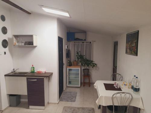 a kitchen with a counter and a table in a room at Liliana Home in Bucharest