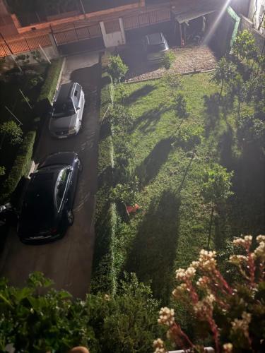 two cars parked on a road in a yard at Cozy Room Close to the Airport in Kamëz