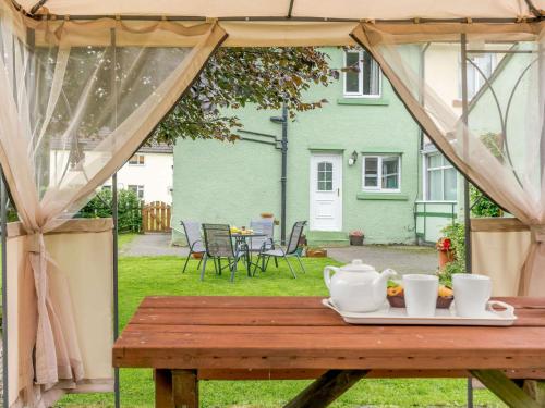 a wooden table with a plate of food on it at 2 Bed in Kielder 89299 in Falstone