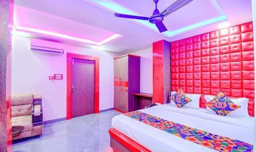 a bedroom with a bed and a ceiling fan at FabHotel Asha Inn in kolkata