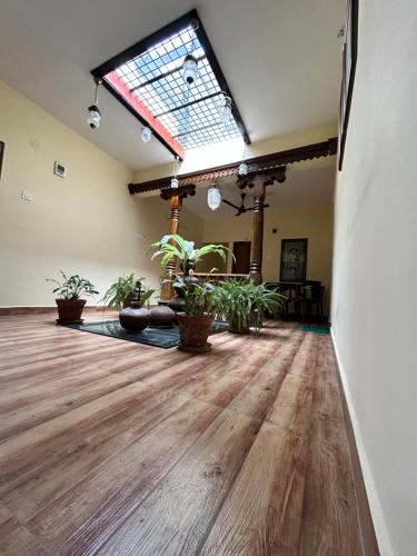 an empty room with potted plants and a large window at Shubham Suites & Party Hall in Hubli