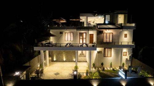 a large white house at night with lights at Villa Mossa Ambalangoda Boutique villa in Ambalangoda