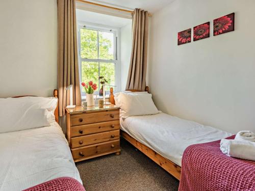 a bedroom with two beds and a window at 2 Bed in Keswick SZ027 in Keswick