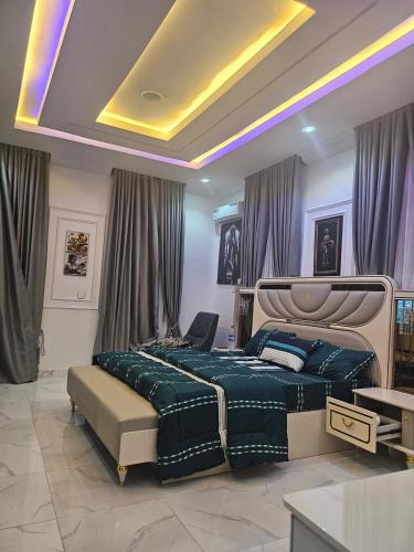 a bedroom with a large bed and a couch at luxury 3bed rooms duplex lekki Lagos nigeria in Lekki